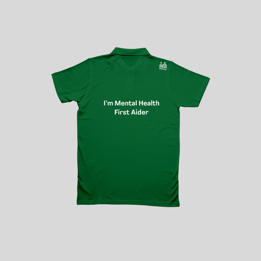 A green short-sleeve polo shirt shown from the back, featuring the white printed text 'Leading a Mentally Healthy Team' across the center and a small white logo on the upper right shoulder, displayed against a solid gray background.