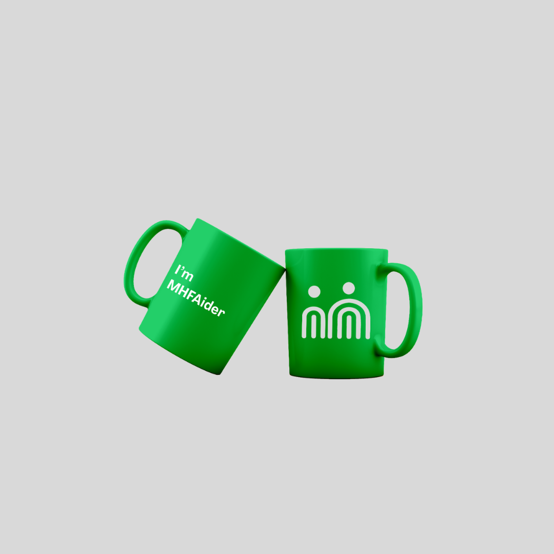 Two bright green ceramic mugs on a light gray background. One mug is tilted and shows the white text 'I'm MHFAider'.