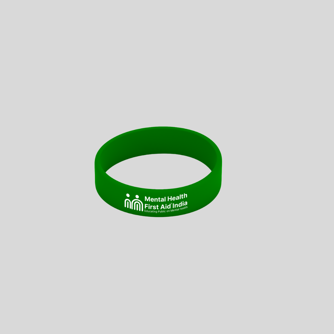 A green silicone wristband with white printed text reading 'Mental Health First Aid India' and a small icon, shown on a plain light gray background.